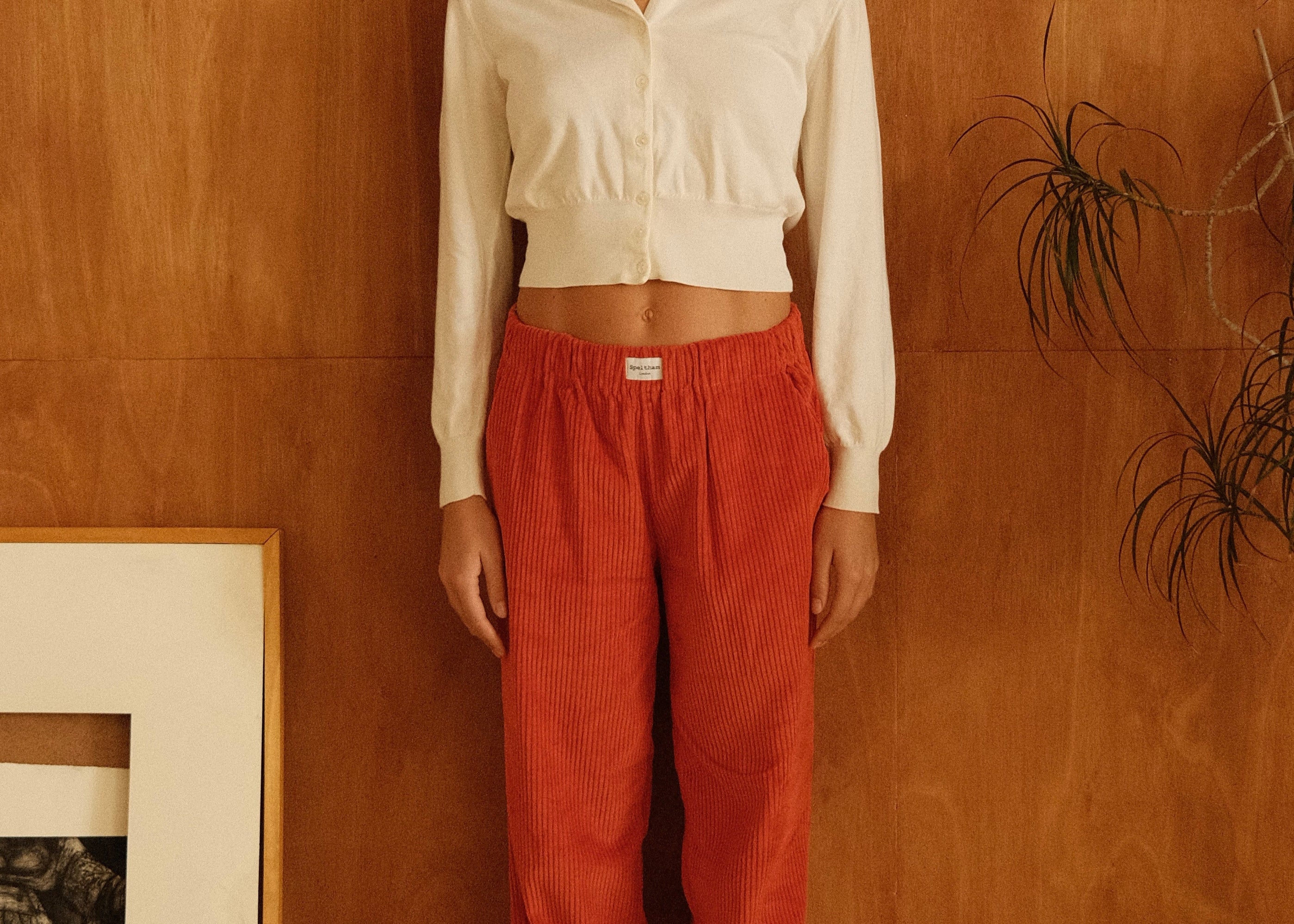 female model wearing orange speltham corduroy lounge pants
