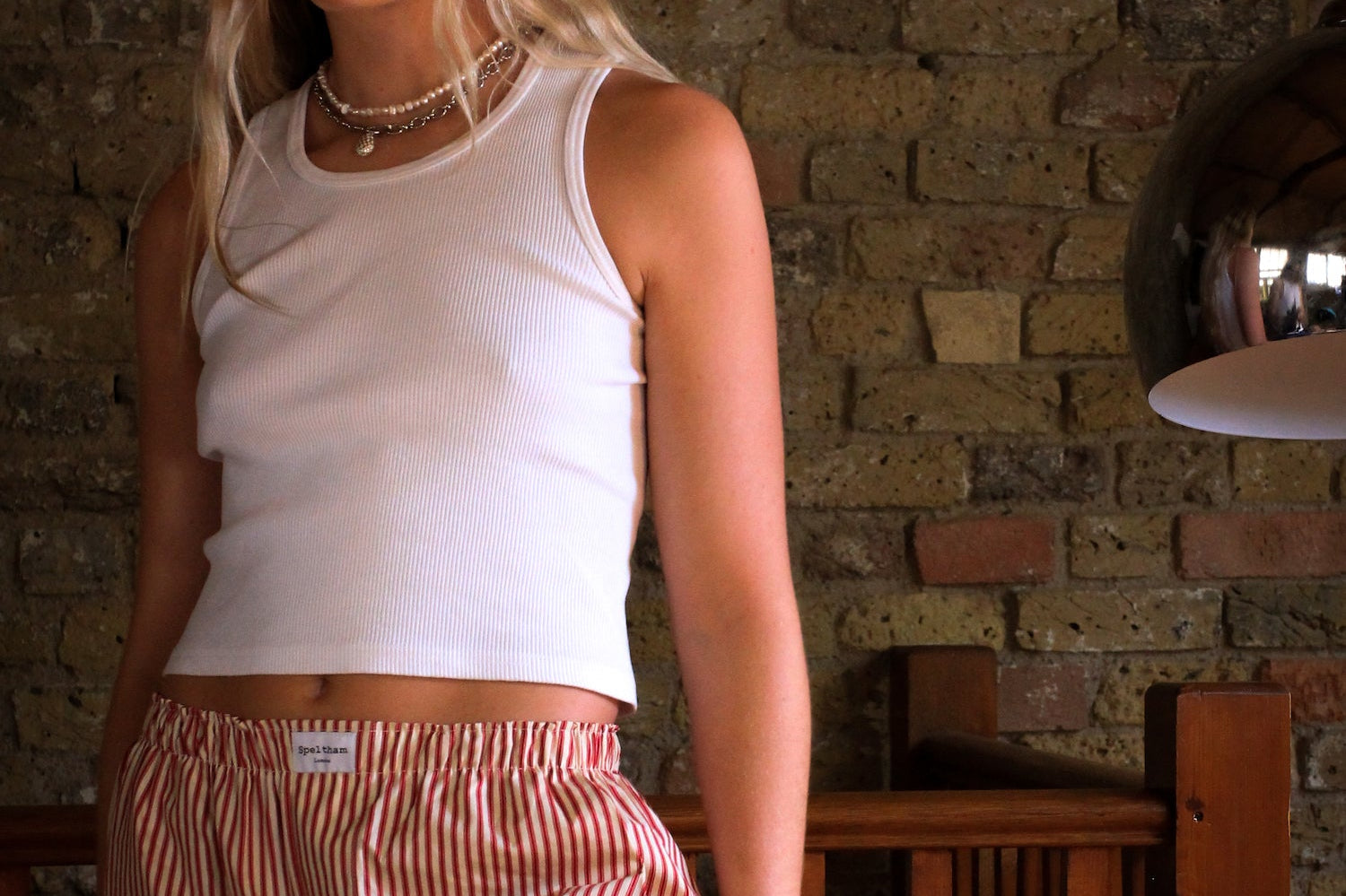 girl wearing red striped speltham lounge pants