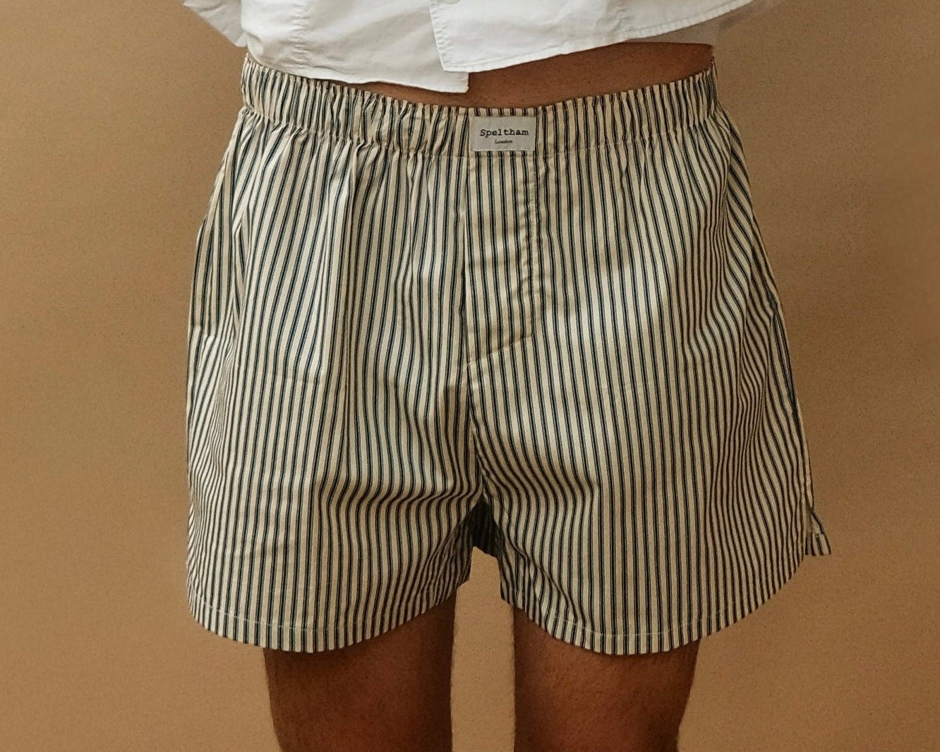 Striped unisex boxer shorts with Speltham label, paired with white shirt for casual loungewear