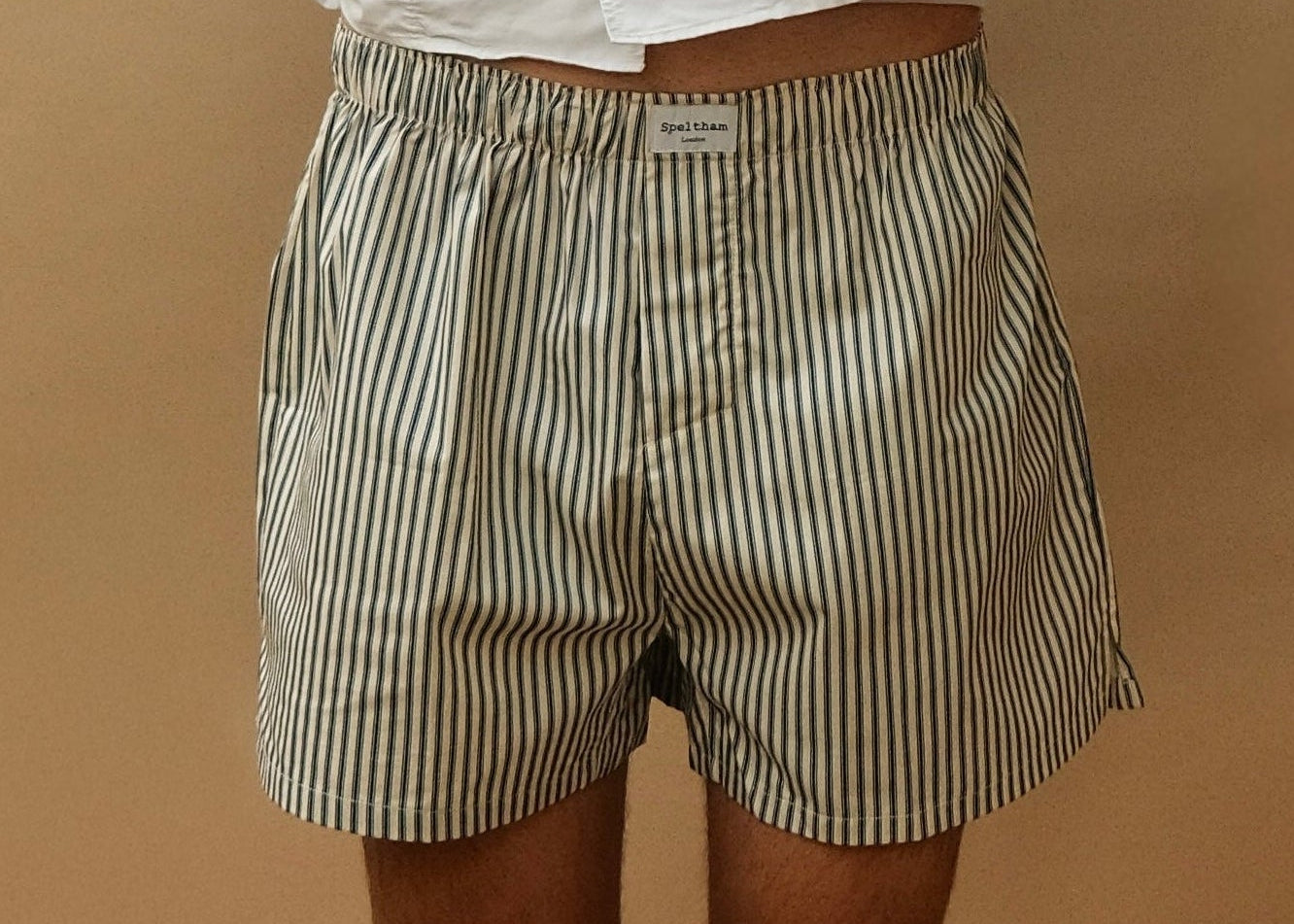 Striped unisex boxer shorts with Speltham label, paired with white shirt for casual loungewear