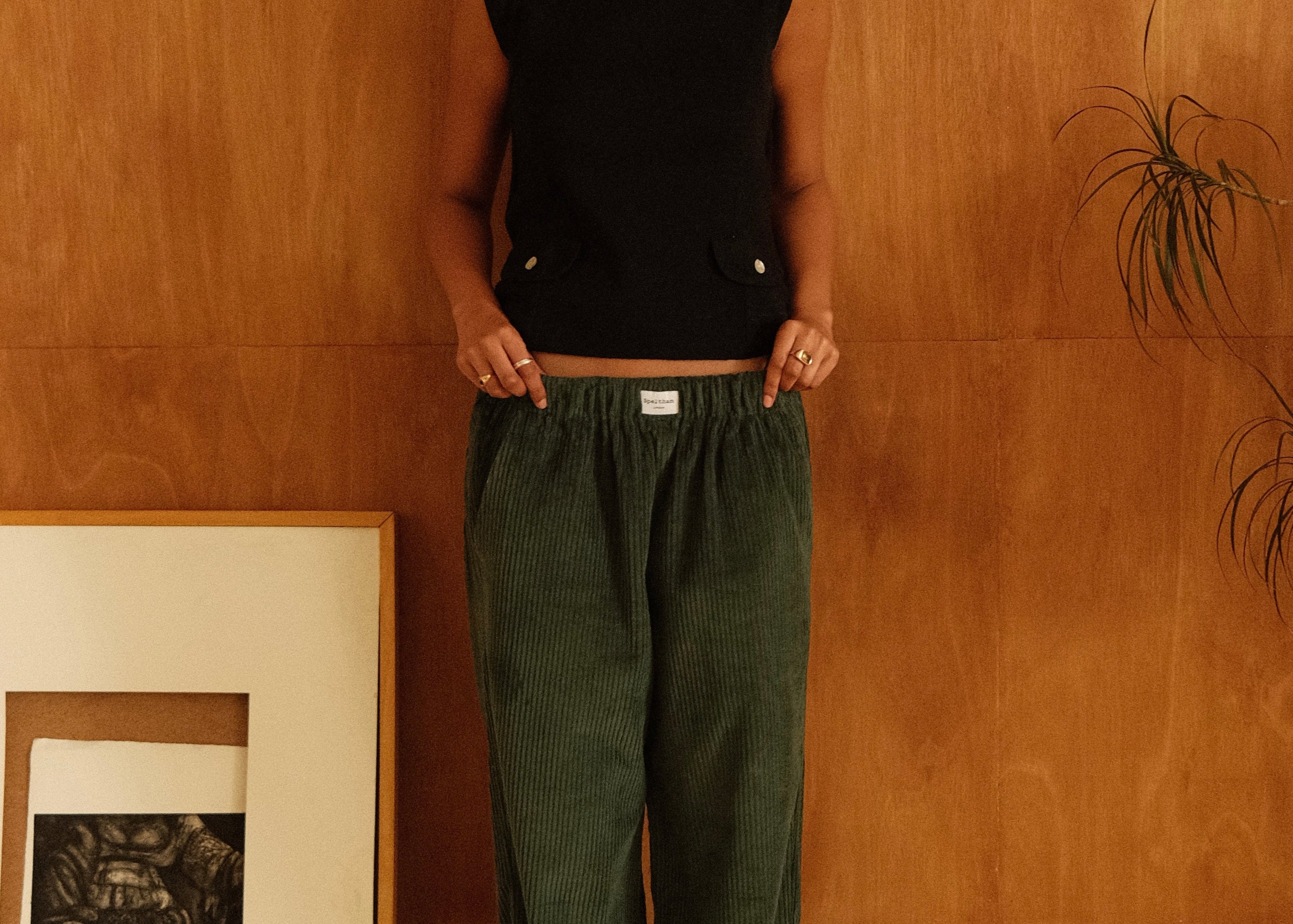 female model wearing speltham dark green corduroy lounge trousers