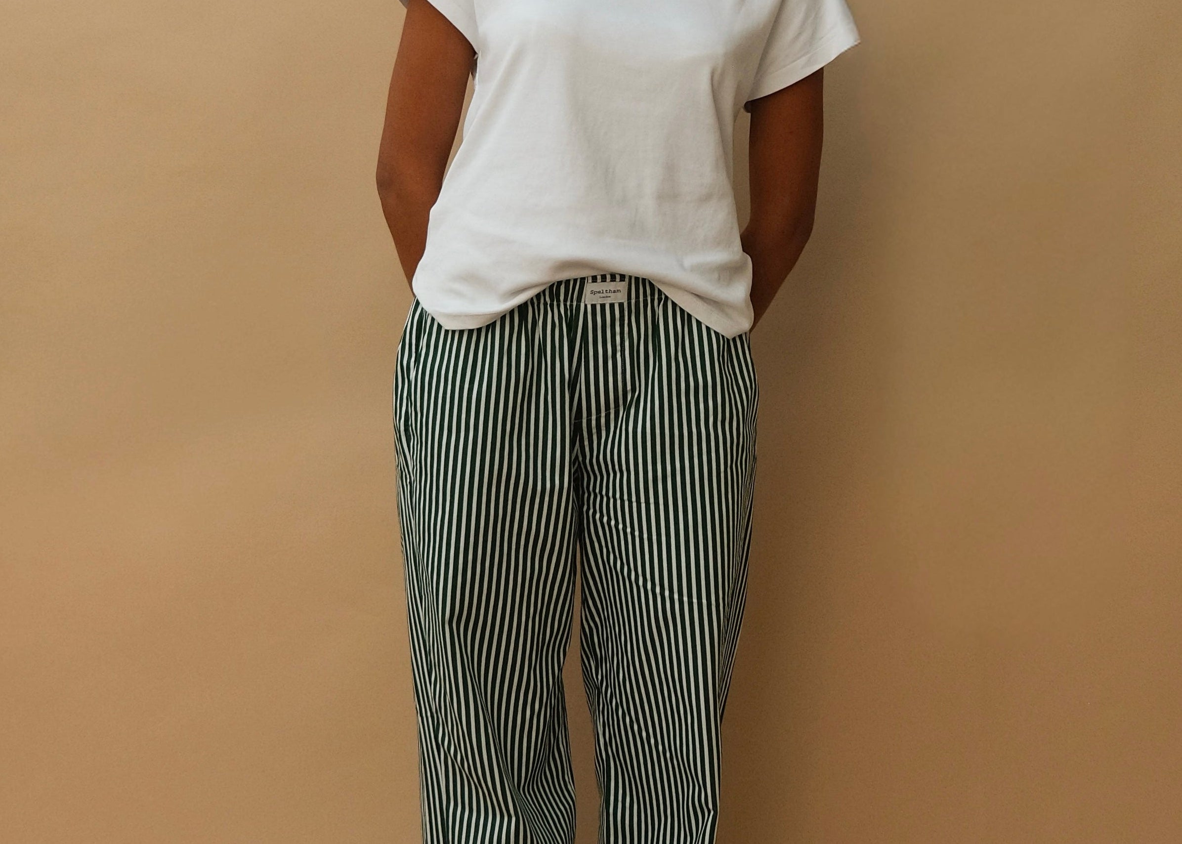 female model wearing green striped speltham lounge pants