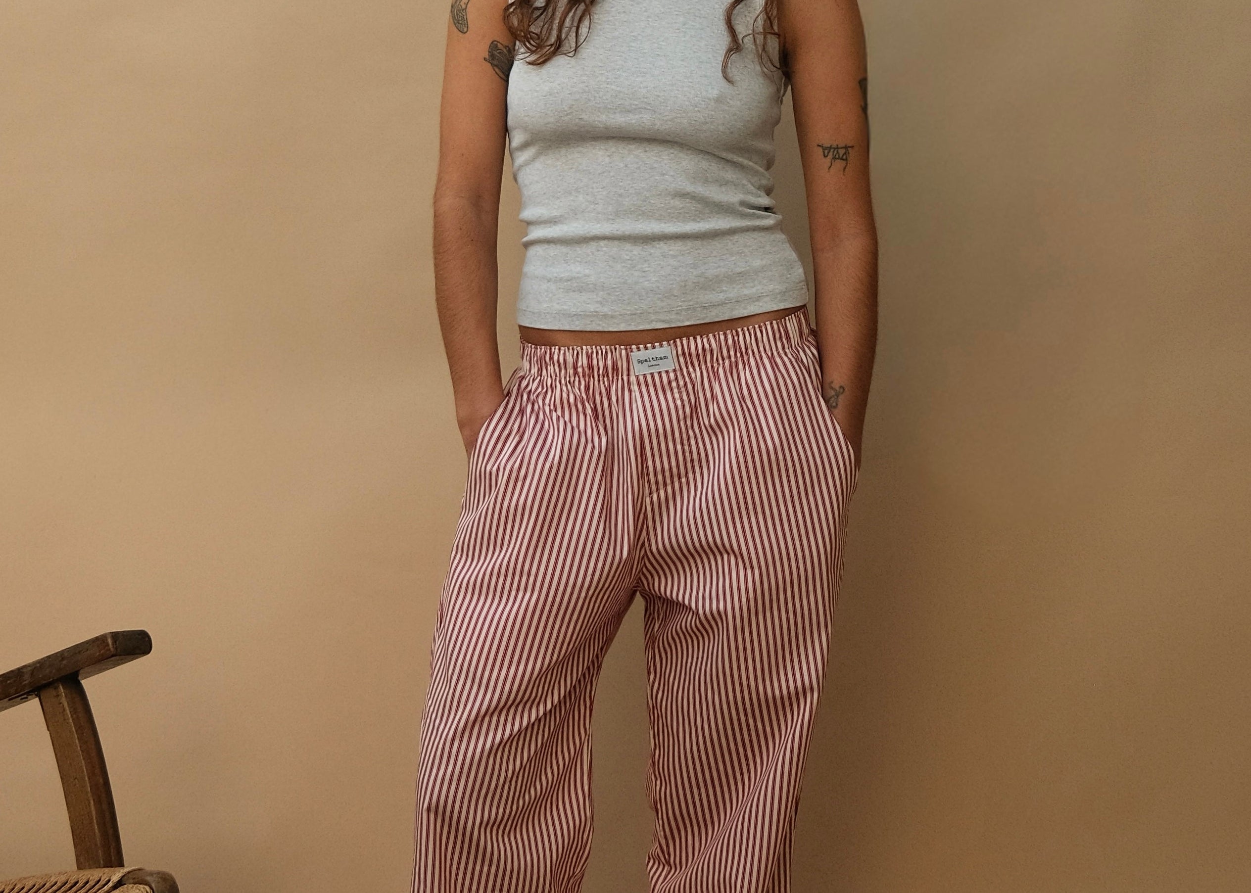female model wearing red striped speltham lounge pants